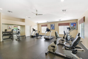 bright fitness center with treadmills and various fitness equipment