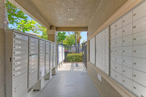covered outdoor mailboxes on left and right sides of walking area