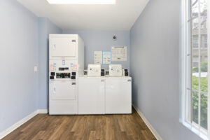 Interior Laundry facilities, Blue walls, wood floors, 2 washers 2 dryers.