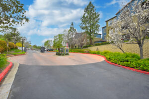 Exterior overlook at anaheim hills entrance gate, roundabout, meticulous landscaping, lush foliage, photo taken on a sunny day.