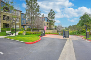 Exterior overlook at anaheim hills entrance gate, roundabout, meticulous landscaping, lush foliage, photo taken on a sunny day.